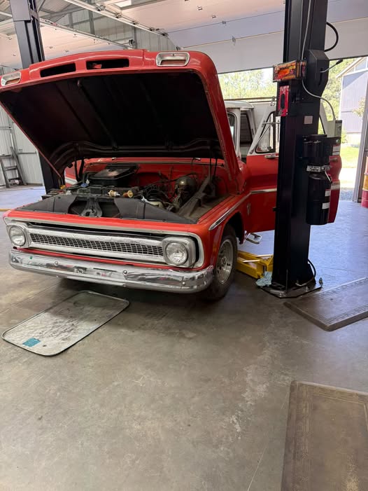 Truck in bay with hood open for repair